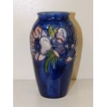 A William Moorcroft blue ground Anemone vase, 7” high