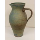 A studio pottery jug in mottled blue & brown glazes – 'JB?'