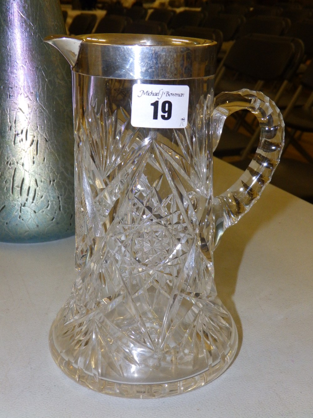 A silver-rimmed cut glass jug – Birmingham 1946, 8” high