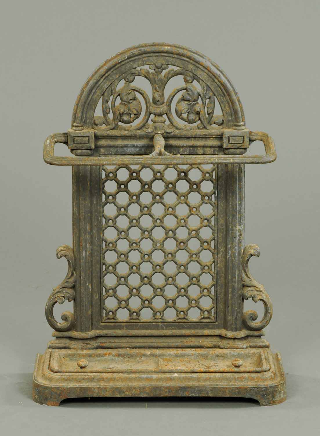 A Victorian cast iron hall stick stand, with drip tray.  Width 21.5 ins.  CONDITION REPORT: Other