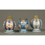 A garniture of three lidded vessels, with plated mounts, Imari colours.  Height of pair 5.5 ins.