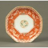 A Chinese octagonal plate, 19th century, decorated with foliate panels and with stilt marks to