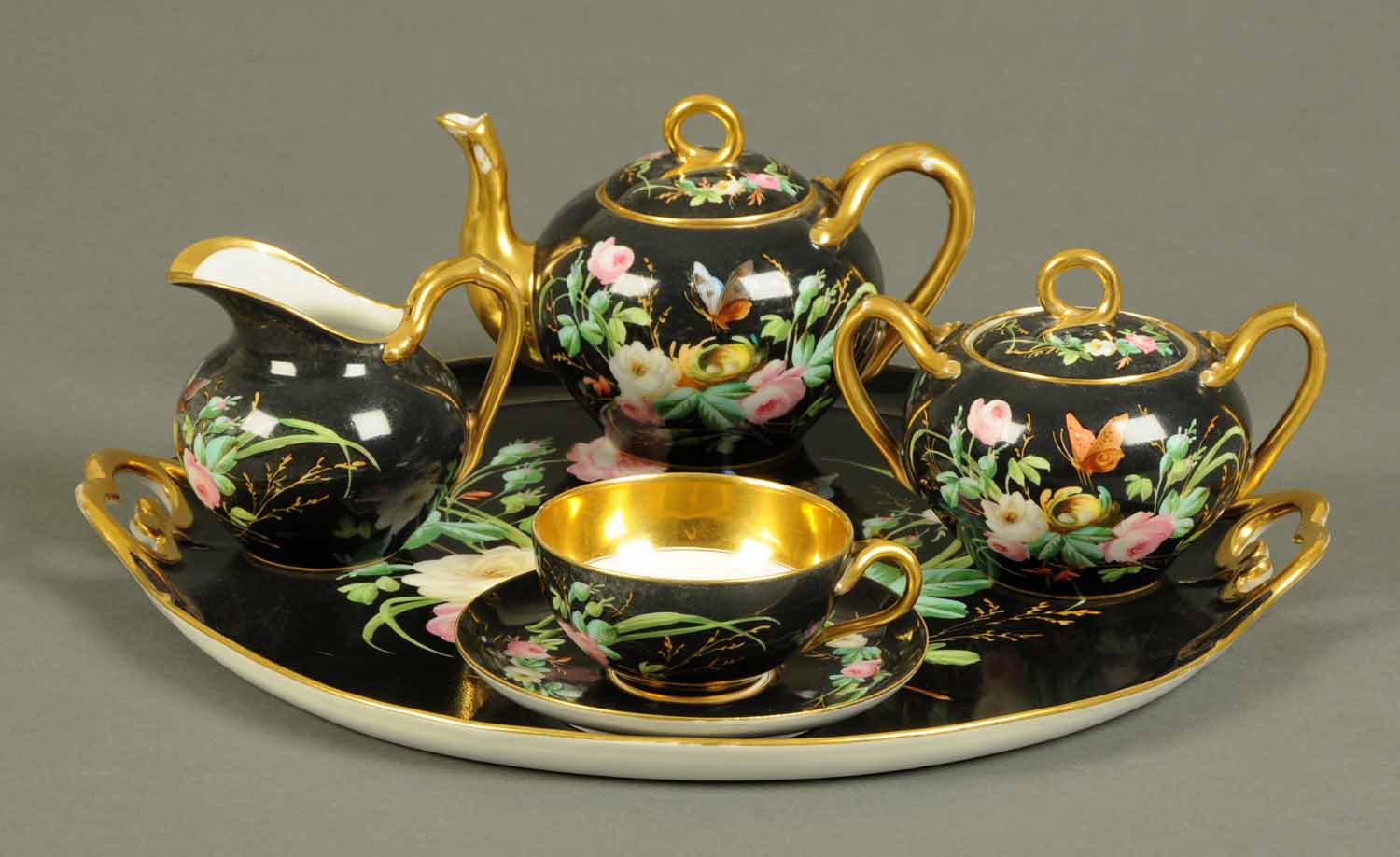 An early 20th century German porcelain Bachelors tea service, comprising tray, teapot, sugar