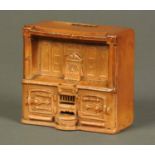 A 19th century earthenware Nisbets Patent money box, in the form of a kitchen range.  Width 5 ins.