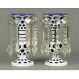 A pair of blue and milk glass overlay lustres, each with faceted drops.  Height 9 ins.