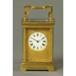 A large French brass carriage clock, with two-train movement, Anglaise case and brass surround to