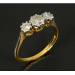 An 18 ct gold platinum and diamond three stone ring, size L/M. CONDITION REPORT: The shank is in