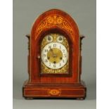 An Edwardian inlaid mahogany mantle clock, with three-train spring driven movement,