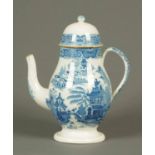A late 18th/early 19th century English coffee pot, blue and white printed with a willow pattern.