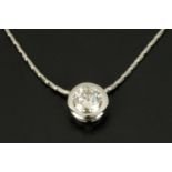 An 18 ct white gold pendant, on a chain, with rubover set diamond weighing 1.31 carats.