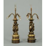 A pair of 19th century bronze vases, with relief moulded putto figures, now converted to