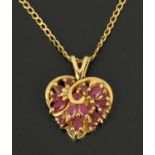 A 9 ct gold heart shaped pendant, set with rubies, with fine link chain.