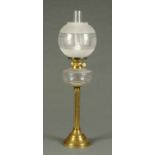 A Victorian brass oil lamp, with glass reservoir and etched glass shade, converted to electricity.