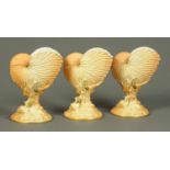 Three Royal Worcester Nautilus shell vases, each with puce marks.  Height 8 ins (see illustration).