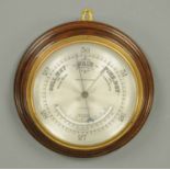 An Edwardian aneroid barometer, by Frodsham & Keen, with silvered brass dial.  Case diameter 11 ins.