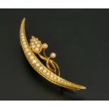 A 15 ct gold crescent brooch, set with seed pearls, hallmarked.  Length 5 cm.