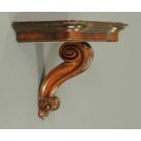 A Regency walnut clock bracket, with single scroll support.  Width 19 ins.  CONDITION REPORT: The