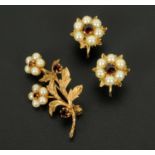 A 9 ct gold leaf brooch and matching ear clips, set with garnets and pearls.