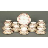 An Aynsley tea service, comprising eleven cups, twelve saucers, twelve plates, sandwich plate and