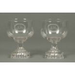 A pair of Regency glass goblets, with lemon squeezer bases, initialled JM.