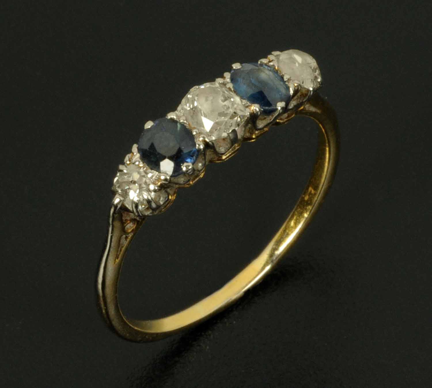 A sapphire and diamond five stone ring, with yellow gold coloured metal shank, hallmark rubbed, size