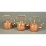 Three Victorian copper kettles, with S scroll spouts, carrying handles and acorn finials to lids.