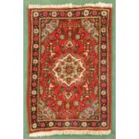 An Iranian small rug, with fringed ends, multicolour foliate pattern.  40 ins x 23.5 ins.