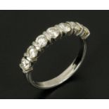 An 18 ct white gold seven stone diamond set ring, diamond weight 1.