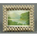 A painted wooden frame surround, with print of Derwentwater.  Frame dimensions 10.5 ins x 12.5