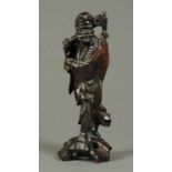 A Japanese carved wooden figure of a sage.  Height 11 ins.
