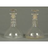 A pair of 19th century glass decanters, each with four ringed neck and ground pontil mark.