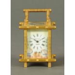 A brass carriage clock, with simulated bamboo style case, with porcelain dial marked "Elliott & Son,