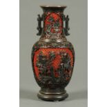 A Chinese Cinnabar lacquer vase, black and red and raised on integral wooden stand.  Height 14 ins.