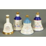 A collection of four Wade porcelain commemorative Bells Scotch Whisky decanters, unopened,