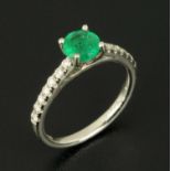 An emerald and diamond platinum set ring, emerald weight .81 carats, size M (see illustration).