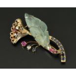 A gold coloured brooch, set with tourmaline, diamonds, sapphires and rubies.  Length 2.