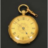 An 18 ct gold ladies fob watch, foliate engraved and with gold coloured face.