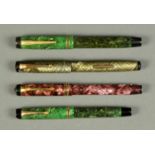 Four fountain pens, Conway Stewart (purple), Mabie Todd "Swan" (green), and two George S Parker (