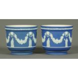 A pair of Wedgwood blue Jasperware jardinieres, decorated with classical figures and swags.