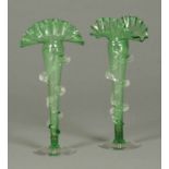 A pair of Victorian green glass vases, with pincered clear glass trailed decoration.  Height 10 ins.