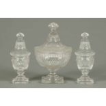 A garniture of three 19th century cut glass vases, each with lid.  Large vase height 11 ins (see