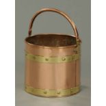 A brass bucket, with copper bindings, rivets and loop carrying handle.  Diameter 11 ins.