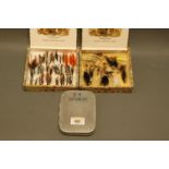 Alloy fly box of salmon flies and 2 wooden cigar boxes of trout and salmon flies.