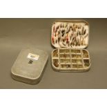 2 alloy fly boxes marked "W" and "D", "W" containing trout flies and having internal leaf, "D"