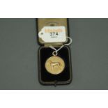 9 ct gold Hounding Trailing Association medal, with trail hound motif to one side, engraved to the