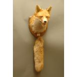 Taxidermy - Fox mask/head mounted on oak shield with brush.  Shield 28 cm, label verso "Whiteclough