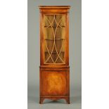 A mahogany corner cabinet, in the George III style, with glazed upper section,