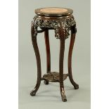 A 19th century Chinese hardwood jardiniere stand, large form, with rouge marble top and low shelf.