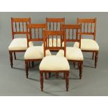 A set of six Edwardian walnut dining chairs, with spindled backs,