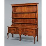 An Edwardian oak dresser with Delft rack, with moulded cornice,